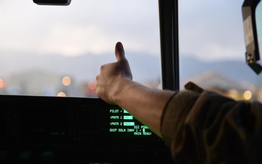 First Lt. Paul Harrington, 25, of Cumberland, R.I., signals to ground crews that his C-130J is ready to head to the runway, at Bagram Air Field, Afghanistan, May 4, 2017.