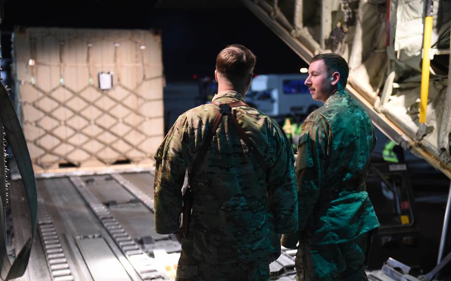 Maj. Timothy Fast, 34, of Baltimore, Ohio, the C-130J’s pilot, and Senior Airman Ryan Berry, 26, of Bedford, Texas, the aircraft’s loadmaster, await cargo at Kandahar Air Field, Afghanistan, May 5, 2017.