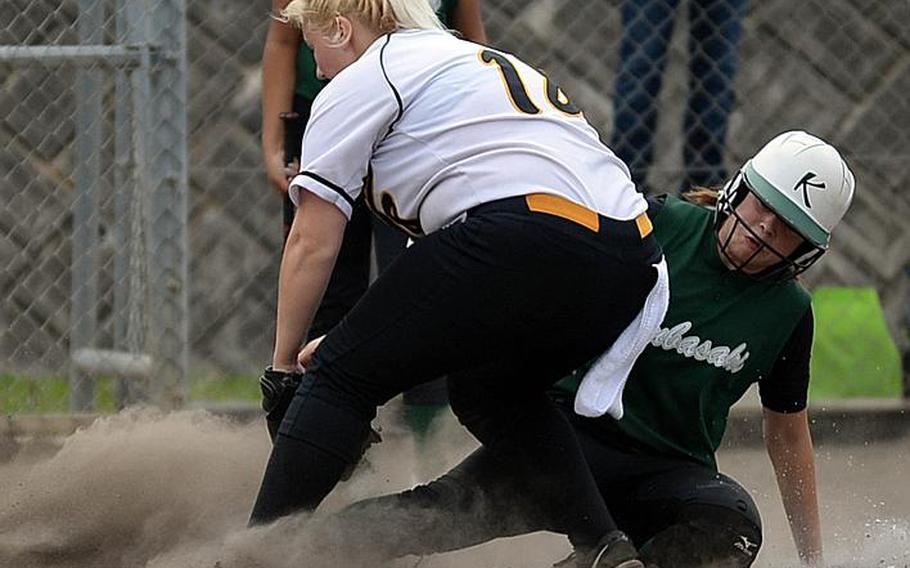 Kubasaki senior Reaven East, right, slides in under the tag of Kadena junior pitcher Lauren Erp during Thursday's Game 1 of the Okinawa district softball best-of-three finals. The Dragons won 17-9 and host Game 2 on Friday.