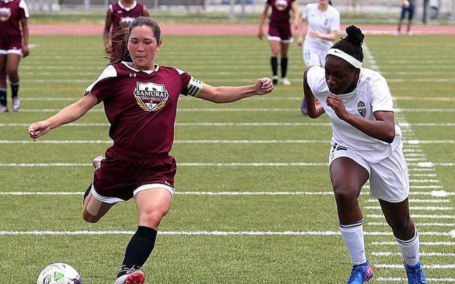 Matthew C. Perry's Bobbi Hill launches a shot against Yokota's Jamia Bailey during Tuesday's pool-play match in the Far East Girls Division II Soccer Tournament, won by the Samurai 4-0.

AUSTIN LIVENGOOD/SPECIAL TO STRIPES