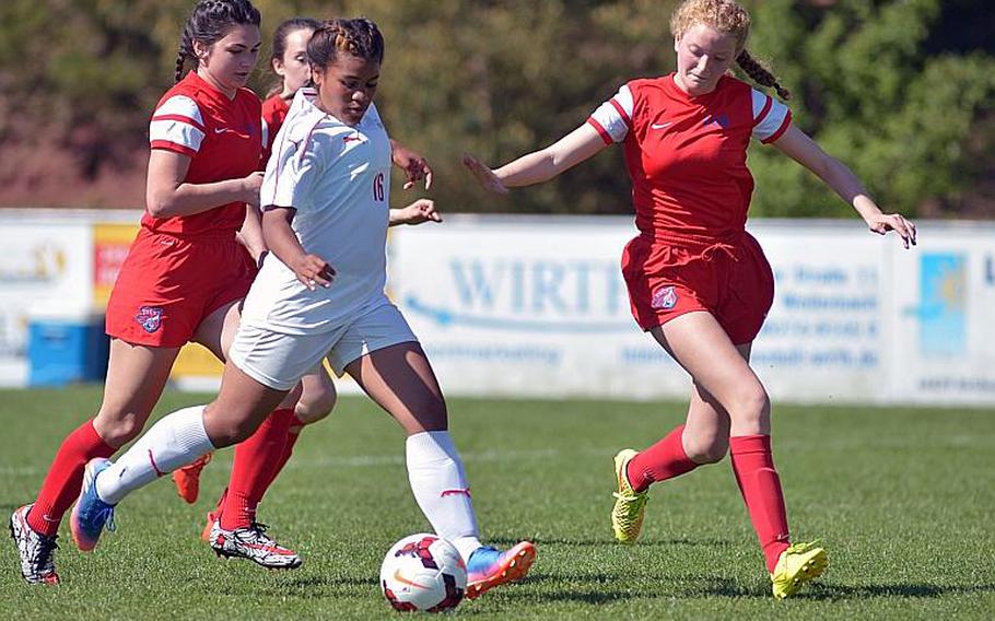 Kaiserslautern's Paola Zorilla scores a goal as ISB's Hannah Hauch tries to block her in a Division I game at the DODEA-Europe soccer championships in Reichenbach, Germany. Kaiserslautern won 2-0.