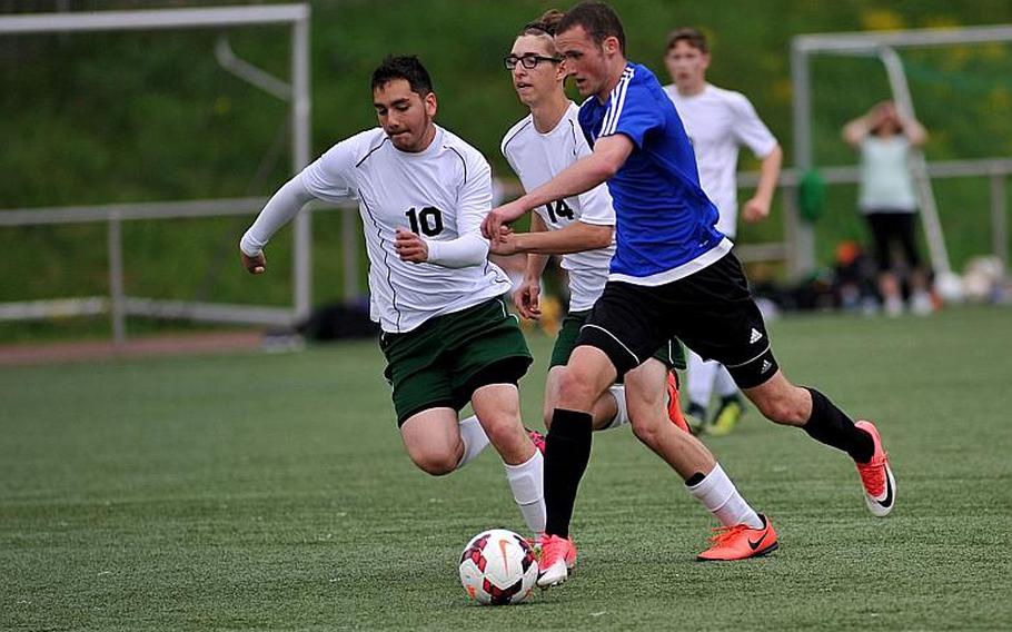 Hohenfels' Ben Harrison on his way to scoring a goal as Alconbury's Devon Anderson, left, and Robert Diamond try to defend. Hohenfels beat the Dragons 2-1 in Division III action at the DODEA-Europe soccer championships in Landstuhl, Germany.
