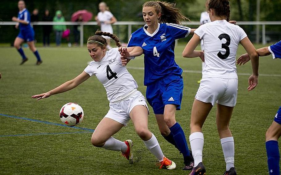 Wiesbaden's Lily Hogenson tries to get to the ball past Naples' Isabella Wolstenholme, left, and Cora Houseworth during the DODEA-Europe Division I semifinals in Reichenbach, Germany, on Friday, May 19, 2017. Wiesbaden won the match 3-1.

MICHAEL B. KELLER/STARS AND STRIPES