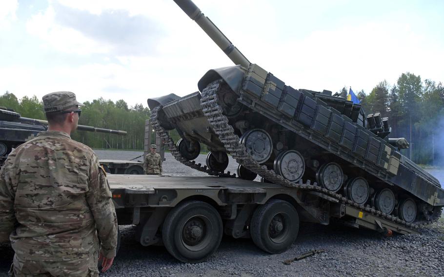 An American soldier supervises the loading of a Ukrainian T-64 tank onto a British Heavy Equipment Transporter at Grafenwoehr, Germany, Tuesday, May 23. The tanks are being transported to Hohenfels, Germany, to take part in Exercise Combined Resolve.