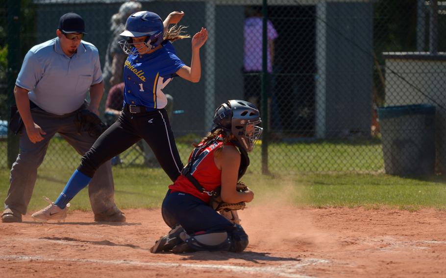 Sigonella's McKenzie Taylor avoids Aviano catcher Eliana Morales as she tags home in a Division II/III game at the DODEA-Europe softball tournament in Ramstein, Germany, Thursday, May 25, 2017. Sigonella won 14-12