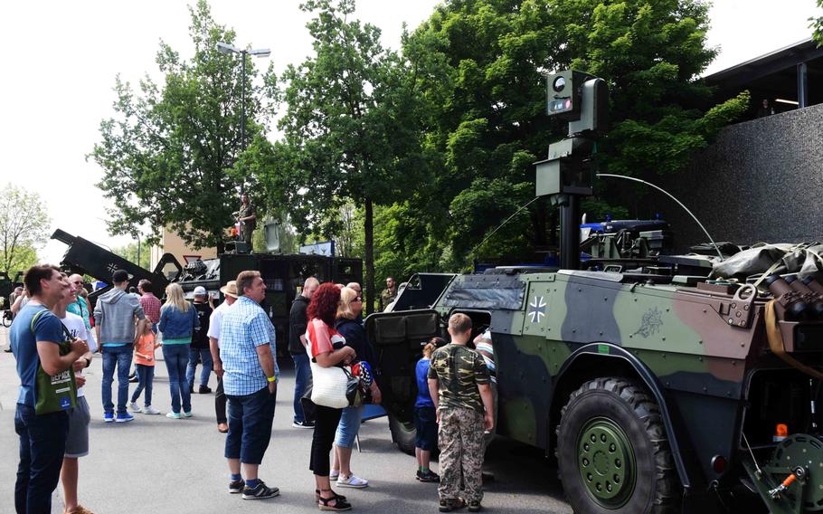 Americans and Germans look at the German army's Fennek Light Armored Reconnaissance Vehicle at the Day of the German Army in Weiden, Germany, Saturday, June 10, 2017.