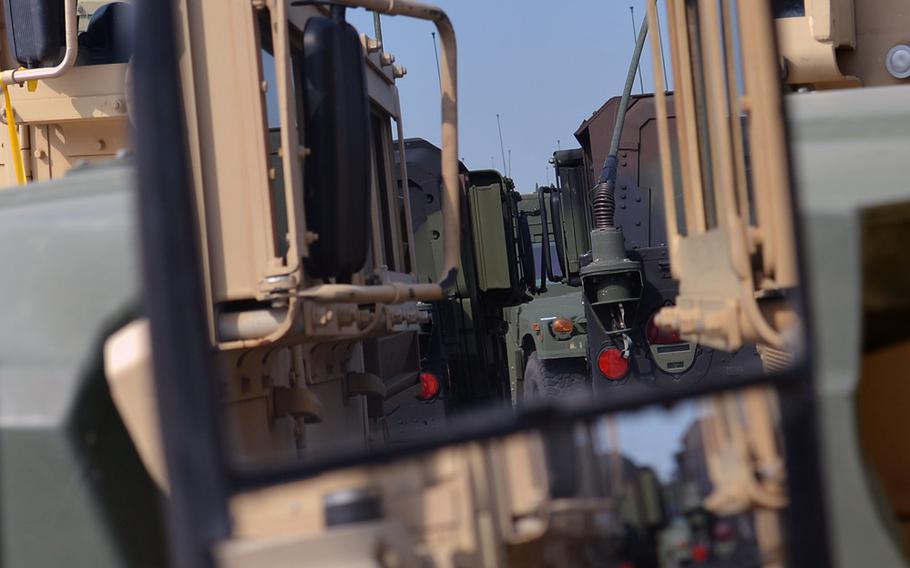 Rows of vehicles can be seen in the mirror of a Humvee at Coleman Barracks in Mannheim. As part of the U.S. Army's prepositioned stocks operation, close to 20,000 pieces of equipment are stored here. They range from M-149 Water Buffalo trailers to M1A1 Abrams tanks.