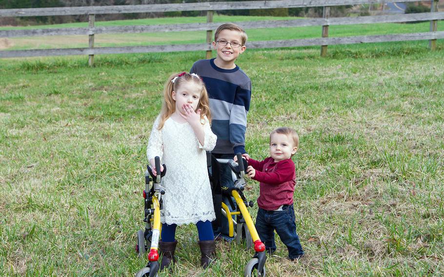 Lillianna Shull, 6, stands in front of her wheelchair for a photo with siblings Jake, 8 and Luke, 1,  in December 2015. Lilli, who had brain cancer, died on Feb. 20.