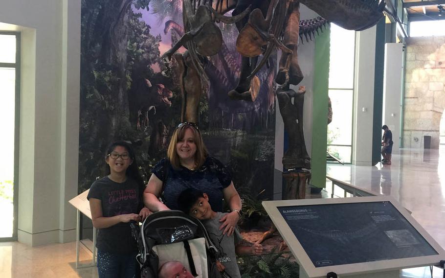 Nathan Tarwater, 17, visits his favorite dinosaur exhibit with his sister Addison, 11, left, his mother Adreanna and his younger brother Caden, 7, on May 14, 2017 at the Witte Museum in San Antonio, TX. Nathan, who was born with a rare choromosome disorder that renders him medically fragile, has defied doctors predictions that he would not survive to his first birthday.