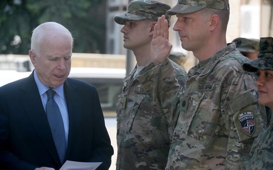 Sen. John McCain, R-Ariz., left, promotes Army Maj. Samuel Fuller, right, to lieutenant colonel at a ceremony in Kabul to mark Independence Day on Tuesday, July 4, 2017. Air Force Tech. Sgt. Brenton Almeida, center, was promoted to master sergeant at the event.