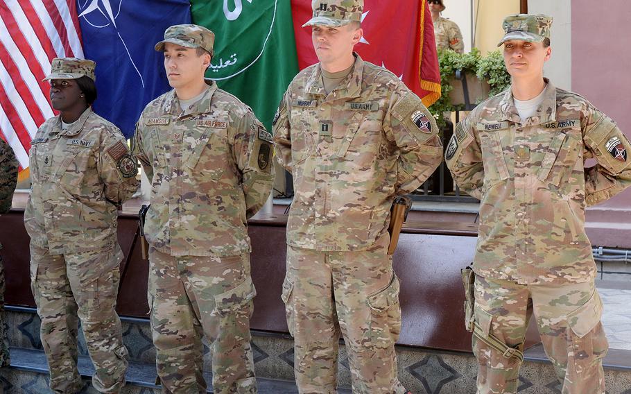 Navy Senior Chief Petty Officer Gail Stockman, from left, Air Force Staff Sgt. Joel Adamson, Army Capt. Benjamin Murray and Army Maj. Jacqueline Newell wait to be awarded medals  from Sen. John McCain, R-Ariz., at a ceremony at NATO's Resolute Support Headquarters in Kabul on Tuesday, July 4, 2017.