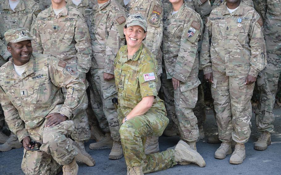 Australian Navy Senior Chief Petty Officer Cath Harvey poses with U.S. sailors at NATO's Resolute Support Headquarters on Tuesday, July 4, 2017.  