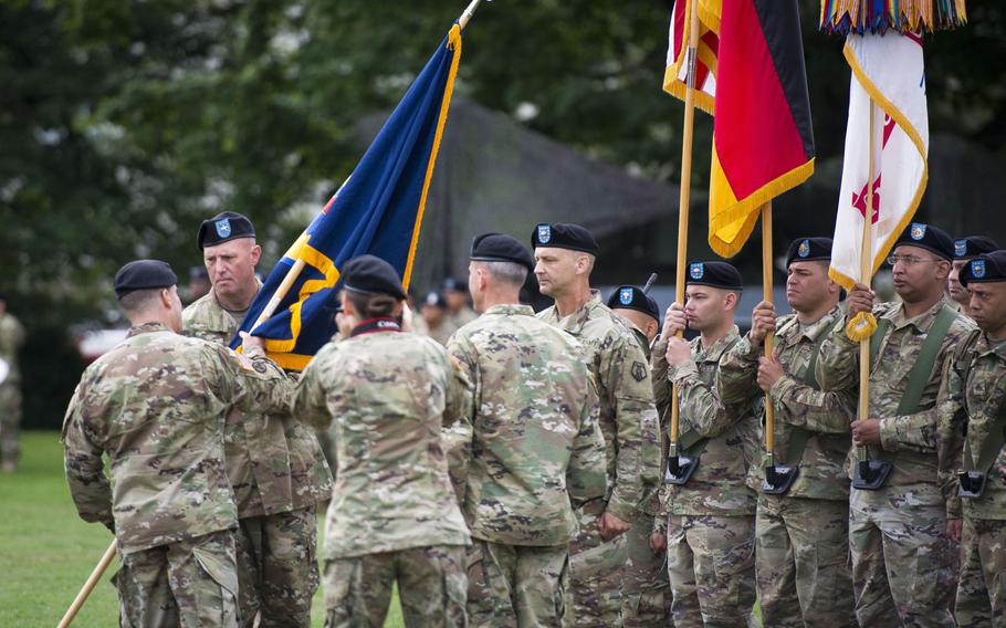 Maj. Gen. Steven Shapiro, 21st Theater Sustainment Command commander, left, passes the 7th Mission Support Command's colors to Brig. Gen. Frederick R. Maiocco Jr. during the MSC's change-of-command ceremony at Daenner Kaserne, Germany, on Friday, Aug. 4, 2017.