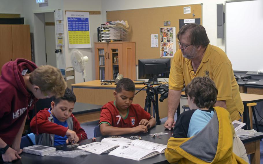 Frank Pendzich, a teacher and robotics club advisor at Wiesbaden High School, speaks to students as they work to assemble a circuitboard during a day camp at the school, Thursday, Aug. 10, 2017.