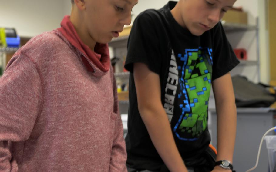 Mason Palmer, left, and Kayden Bell, middle schoolers from Wiesbaden, Germany, prepare to assemble a circuitboard at a summer day camp run by the Wiesbaden High School robotics club, Thursday, Aug. 10, 2017. More than 30 rising middle and high schoolers attended the camp, focused on computer programming.