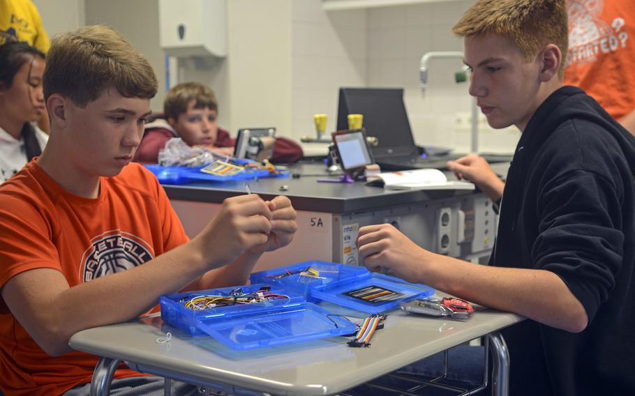 Blake Graham, left, and Paydan Swint, gather materials for a Raspberry Pi learning computer as part of a weeklong summer day camp for rising middle and high schoolers interested in computer programming, Thursday, Aug. 10, 2017 at Wiesbaden High School in Wiesbaden, Germany.