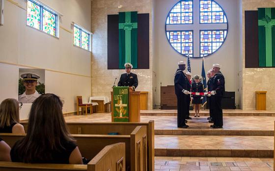 Sailors fold a flag during a memorial service for Lt. Stephen Hopkins inside the Chapel of Hope at Yokosuka Naval Base, Japan, Tuesday, Aug. 22, 2017. Hopkins, assigned to USS Stethem, was reported missing and assumed overboard on Aug. 1, 2017.