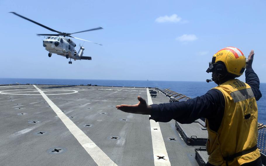 A Japan Maritime Self-Defense Force SH-60J Seahawk helicopter lands on the USS Carter Hall during anti-piracy drills, April 20, 2017.