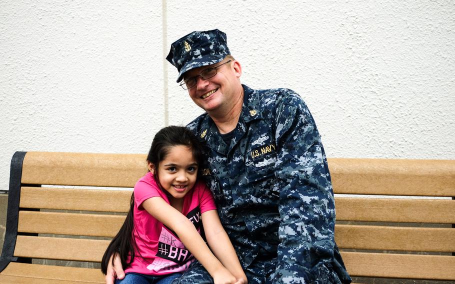Senior Chief Larry Rigdon poses with his daughter, Julianne, a first-grader at Sullivans Elementary School at Yokosuka Naval Base, Japan, Monday, Aug. 28, 2017.