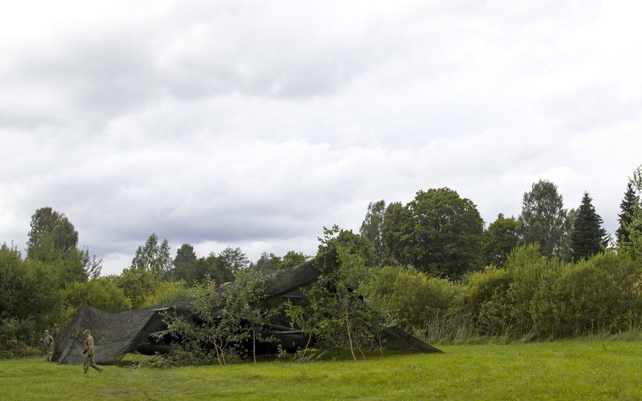 A UH-60 Black Hawk helicopter from 10th Combat Aviation Brigade sits camouflaged in a hide-side during Exercise Falcon's Talon in Latvia on Aug. 21, 2017.