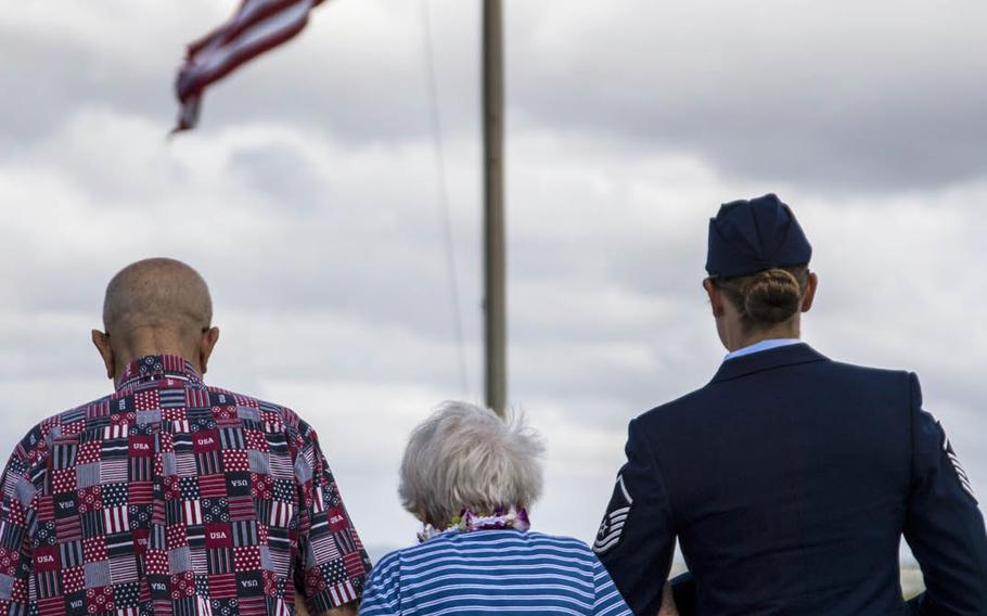 Emily Stone is escorted to scatter the ashes of her husband, Pearl Harbor survivor Melvin Stone, at the USS Utah Memorial at Pearl Harbor, Hawaii, Tuesday, Sept. 19, 2017.