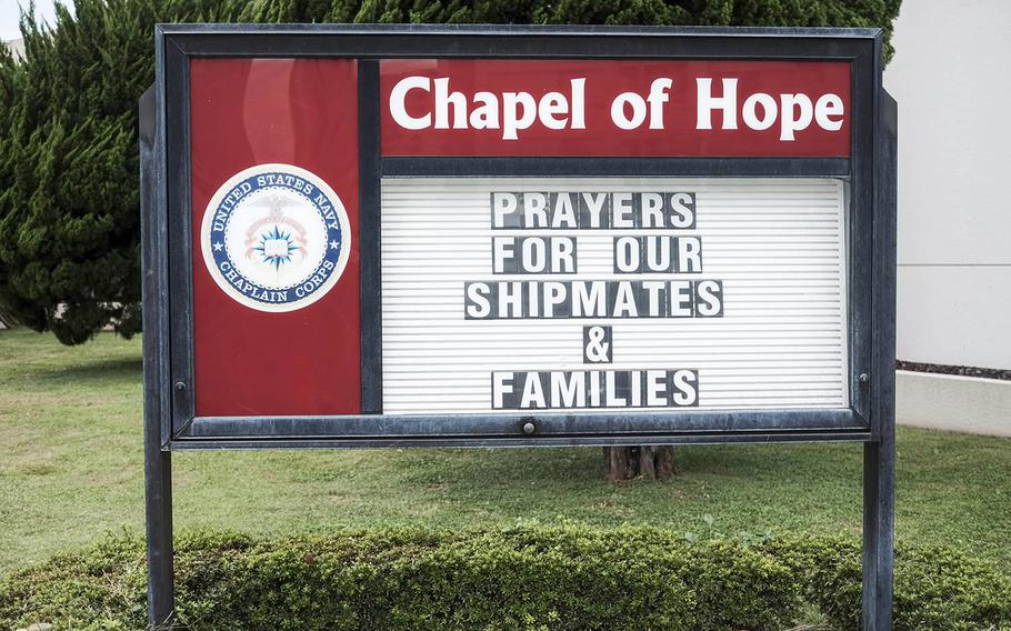 A sign at the Yokosuka Naval Base chapel encourages thoughts and prayers for USS John S. McCain sailors and their families, Wednesday, Oct. 4, 2017. Ten of the destroyer's crew members were killed in an August collision near Singapore.