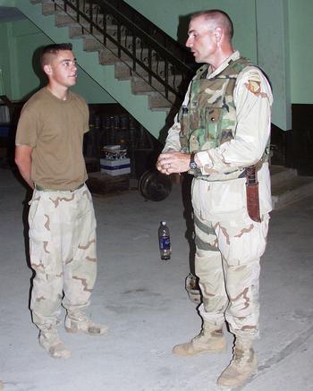Col. Ben Hodges, right, commander of 1st Brigade, 101st Airborne Division prepares to present a coin to Pfc. Levi Fitzgerald, a platoon radio telephone operator with the brigade in Mosul, Iraq in July 2003. Hodges is now slated to retire as the three-star commander of U.S. Army Europe.