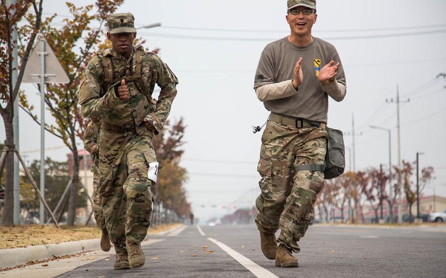 A soldier is urged on during the final stretch of an 18.6-mile march at Camp Humphreys, South Korea, Thursday, Nov. 2, 2017.