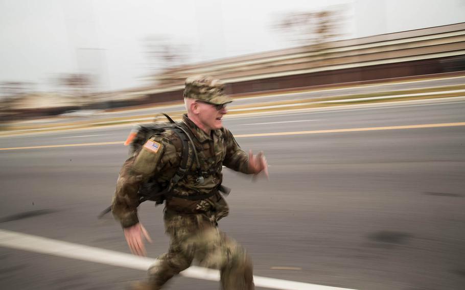 A marcher races to the finish during the annual Kapaun Memorial Ruck March at Camp Humphreys, South Korea, Thursday, Nov. 2, 2017.
