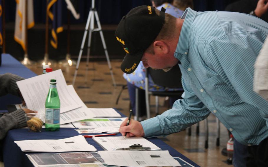 Shawn Scott, a veteran of Desert Storm and Desert Shield, signs up for a clinical trial Nov. 3, 2017, at the Gulf War Illness Awareness Conference in Tampa, Fla. About 13% of veterans had problems paying medical bills and over 8% had forgone medical care altogether, according to the report from the National Center for Health Statistics. 