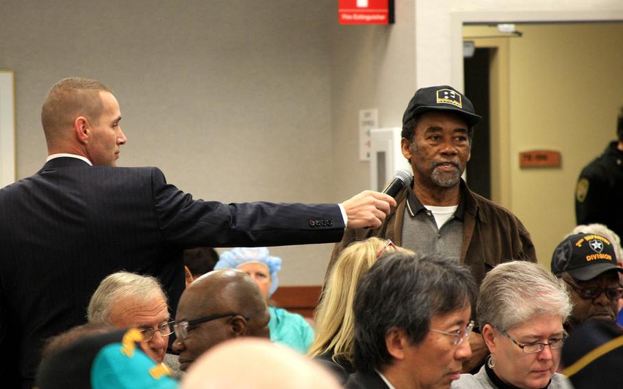 Veteran Freddie McClinton tells Rep. Phil Roe, R-Tenn., Rep. French Hill, R-Ark., and VA officials about his struggles to obtain federal benefits as David Carnahan, a district representative for Hill, holds out the microphone to him. Veterans asked questions and expressed concerns Monday, Nov. 20, 2017 at a town hall meeting at the John L. McLellan Memorial Veterans Hospital in Little Rock.