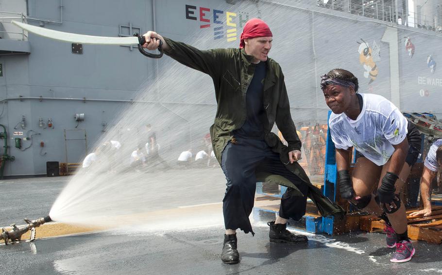 "Pollywogs" aboard the USS Wasp run an obstacle course to become "shellbacks" during a crossing-the-line ceremony in the Atlantic Ocean, Saturday, Nov. 25, 2017.