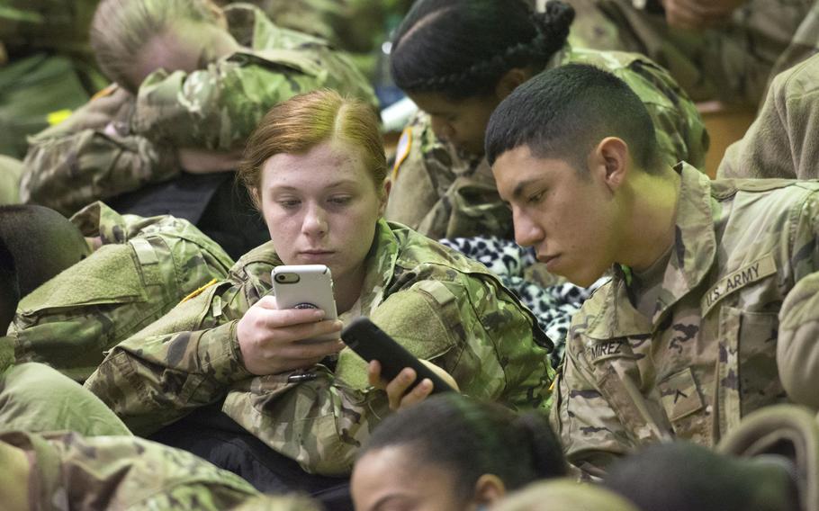Trainees check their cellphones and at Fort Jackson, S.C., on Monday, Dec. 18, 2017, as they prepare to be processed for departure on Victory Block Leave. 