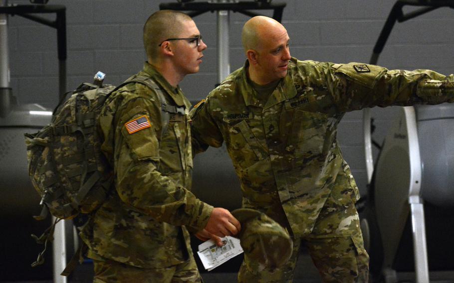 Staff Sgt. James Holloman, with the Army Training Center at Fort Jackson, S.C., motions for a trainee to join a queue for processing out on Victory Block Leave on Monday, Dec. 18, 2017, at the Coleman Gym on post.