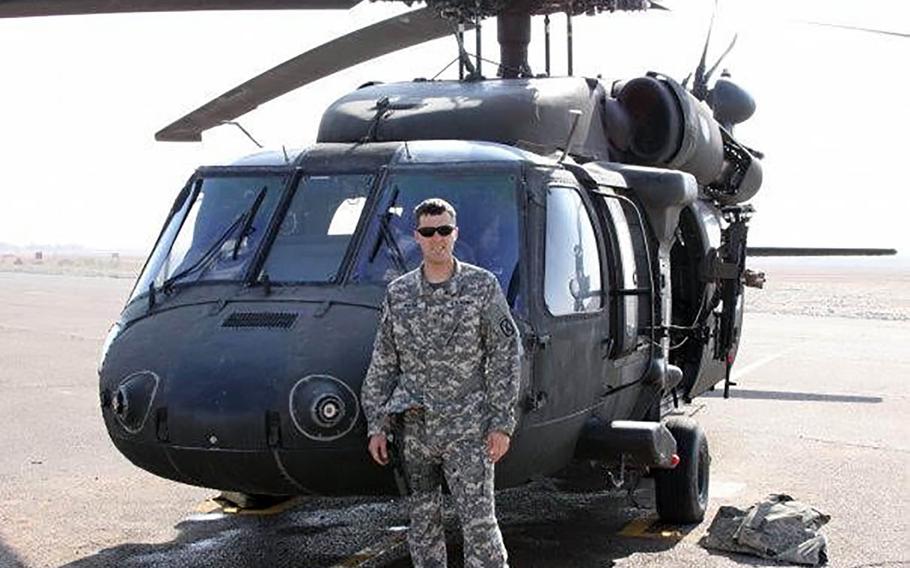 Chief Warrant Officer 2 Mitch Wiese, a medevac pilot with the 10th Mountain Division’s Company C, 3rd General Support Aviation Battalion, 10th Aviation Regiment, pictured here beside his helicopter at FOB Shank in Logar Province, Afghanistan in 2011. Wiese is one of six men followed home from the mission in the documentary "Trauma."