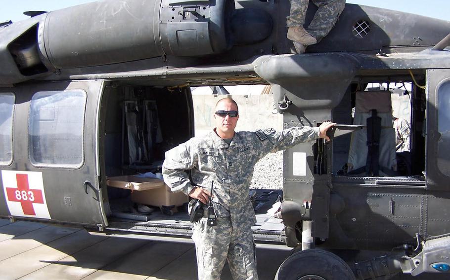 Then Sgt. First Class Michael Walker, a medic belonging to a medevac unit of the 10th Mountain Division’s Company C, 3rd General Support Aviation Battalion, 10th Aviation Regiment, pictured here beside the unit's helicopter at FOB Shank in Logar Province, Afghanistan in 2011. Walker is one of six men followed home from the medevac mission in the documentary "Trauma."