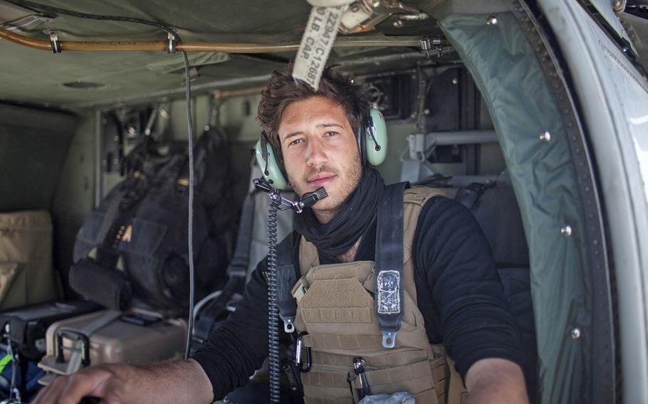 Journalist and documentary filmmaker Harry Sanna sits inside the Black Hawk helicopter belonging to the medevac unit of the 10th Mountain Division’s Company C, 3rd General Support Aviation Battalion, 10th Aviation Regiment in eastern Afghanistan's Logar Province in 2011. Sanna's documentary "Trauam" follows six members of the medevac unit home from the mission.