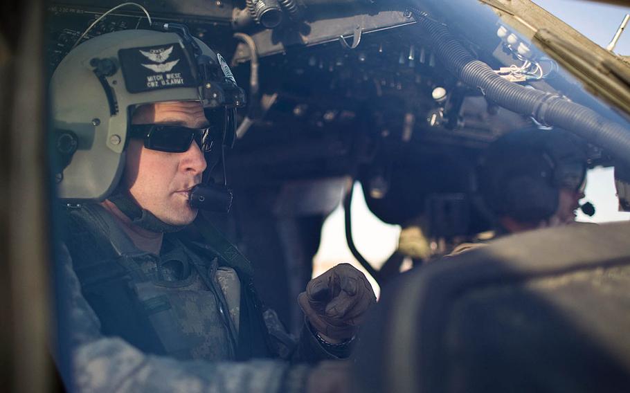 Chief Warrant Officer 2 Mitch Wiese, a medevac pilot with the 10th Mountain Division’s Company C, 3rd General Support Aviation Battalion, 10th Aviation Regiment, pictured in action in his helicopter at in Eastern Afghanistan in 2011. Wiese is one of six men followed home from the mission in the documentary "Trauma."