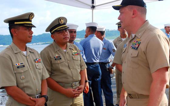Former Navy Cmdr. Troy Amundson, right, seen here speaking with members of the Philippine navy in Subic Bay in 2010, pleaded guilty to a federal bribery charge as part of the ongoing "Fat Leonard" scandal, Tuesday, Jan. 30, 2018.