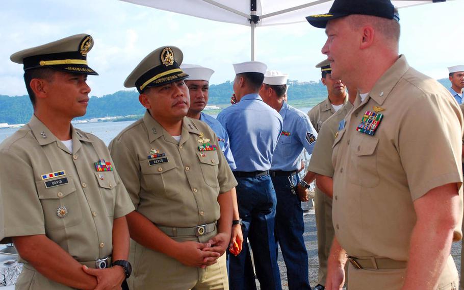 Former Navy Cmdr. Troy Amundson, right, is seen here speaking with members of the Philippine navy in Subic Bay in 2010.