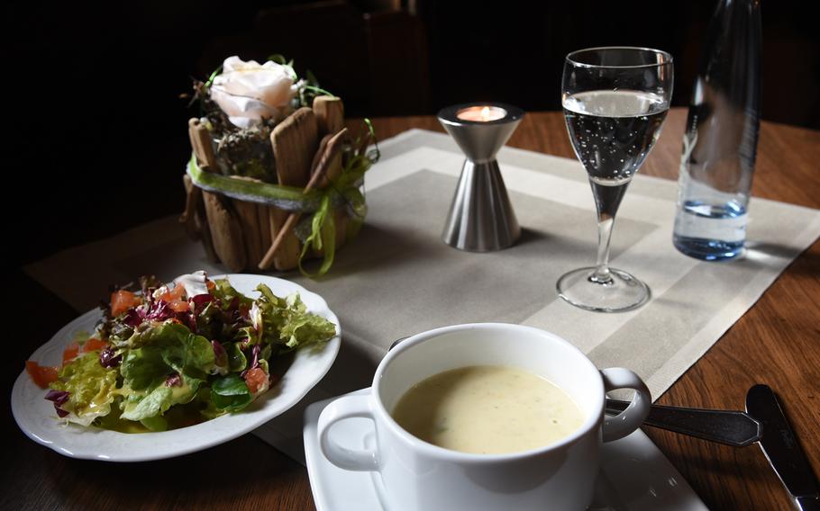 Soup and salad were included with a weekly lunch special in early February at the Schlemmerscheune restaurant in Weilerbach, Germany. The tables had a fancy touch, with a lighted-candle and flower arrangement.