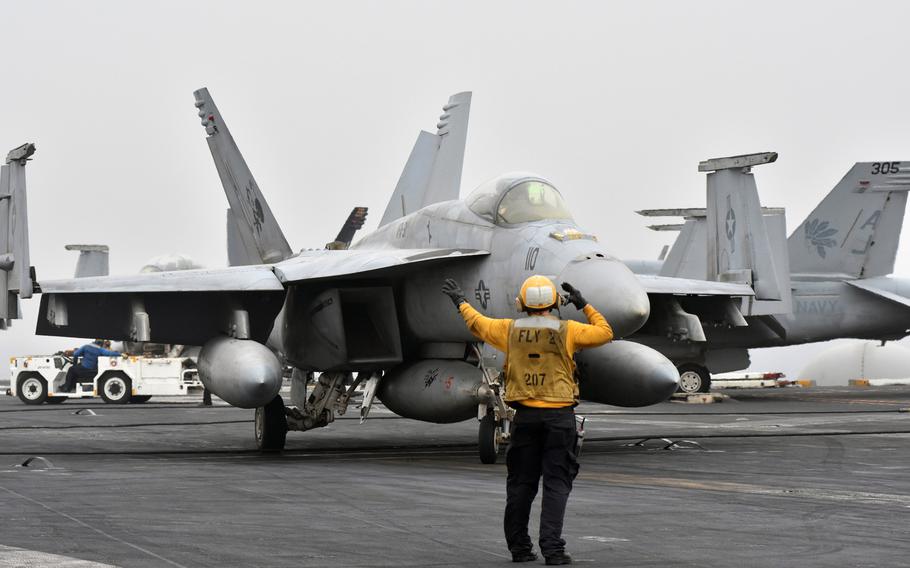 A Super Hornet taxis onto the runway of the USS George H.W. Bush to fly a mission in the Persian Gulf in April 2017. The Navy has awarded Boeing a $73 million contract to begin upgrading its fleet of the aircraft.