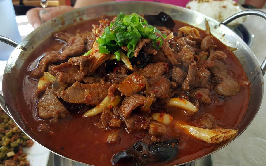 The griddle lamb at Hunan Cuisine in Honolulu simmers on a flame that keeps it piping hot.