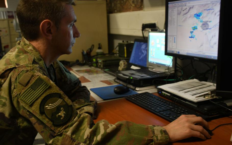 Air Force Maj. William Henning, flight commander of the 451st Expeditionary Operations Support Squadron's meteorological team, analyzes the weather in his office at Kandahar Air Field, Afghanistan, on March 19, 2018.