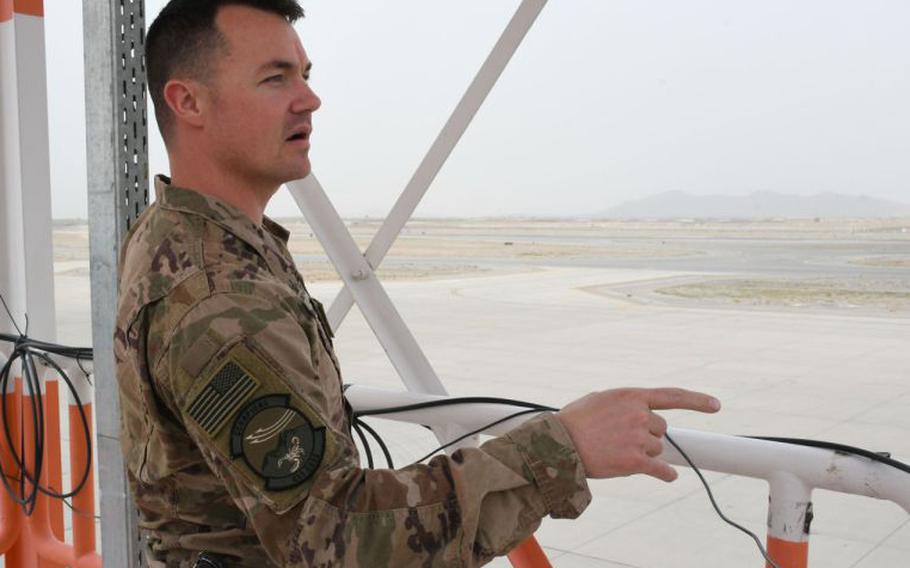 Air Force Master Sgt. Dominick Martin, flight chief of the 451st Expeditionary Operations Support Squadron's meteorological team, observes the weather from the group's observation deck at Kandahar Air Filed, Afghanistan, on March 19, 2018.