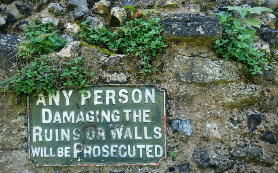 Visitors are warned about damaging what's left of a wall from the 11th-century Benedictine Abbey ruins at the Abbey Gardens in Bury St. Edmunds, England. The Great Gate at the main entrance to the park is the best-preserved feature, with intact stonework from the 14th century.