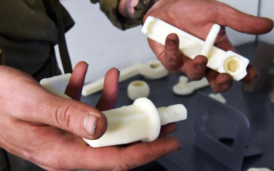 Two 3D-printed Humvee door handles printed with the Rapid Fabrication via Additive Manufacturing 3D printing unit, Hohenfels, Germany, Tuesday, May 8, 2018.