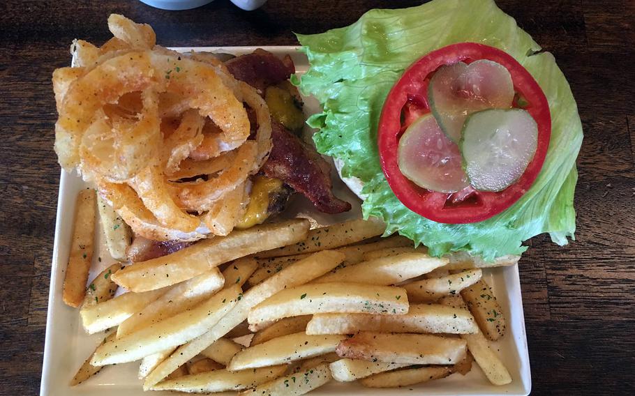 Burger Bear's Mama Bear burger is a beast of a meal: A half-pound patty, garnished with pickles, tomato, lettuce, bacon slices and fried onion rings piled high, accompanied by a side of French fries.