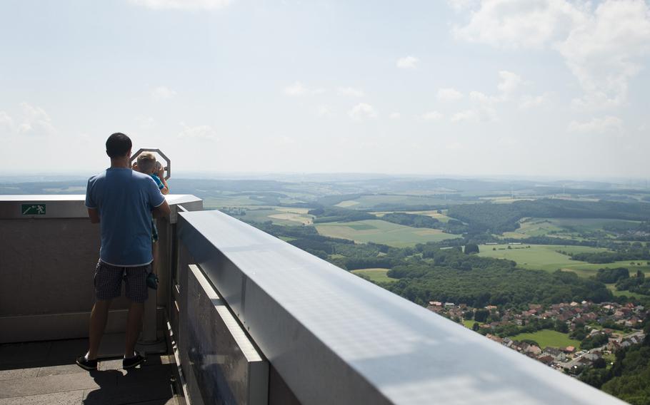 Visitors to the Schaumberg tower in Tholey, Germany, use the coin-operated telescope to view the sights below.