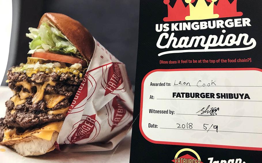 Those who finish the monster, 690-gram Kingburger at Fatburger in Tokyo receive a certificate and their photo on the wall.